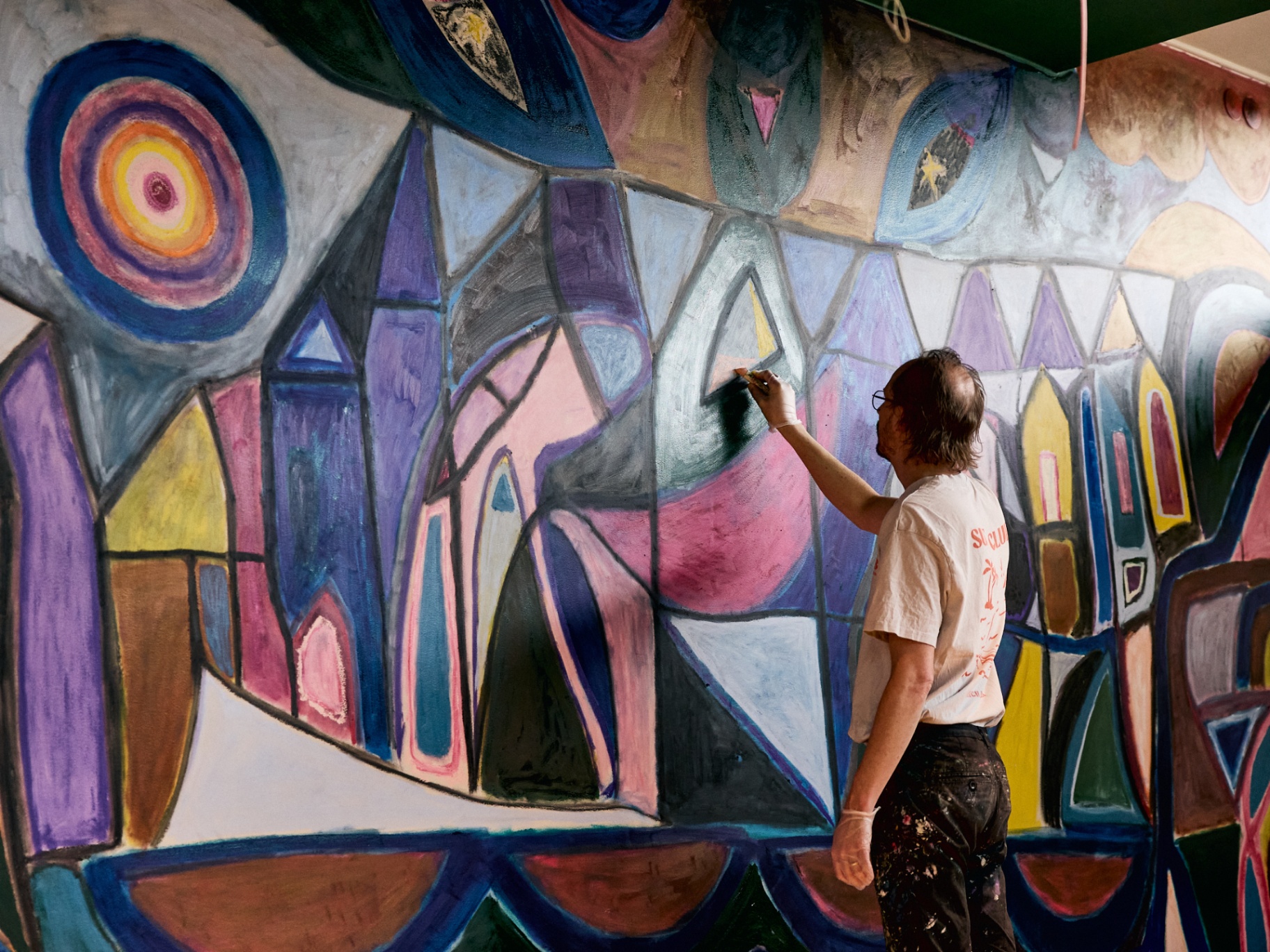 Gustav Hjelmgren painting a permanent wall mural at Scandic Malmen, Stockholm