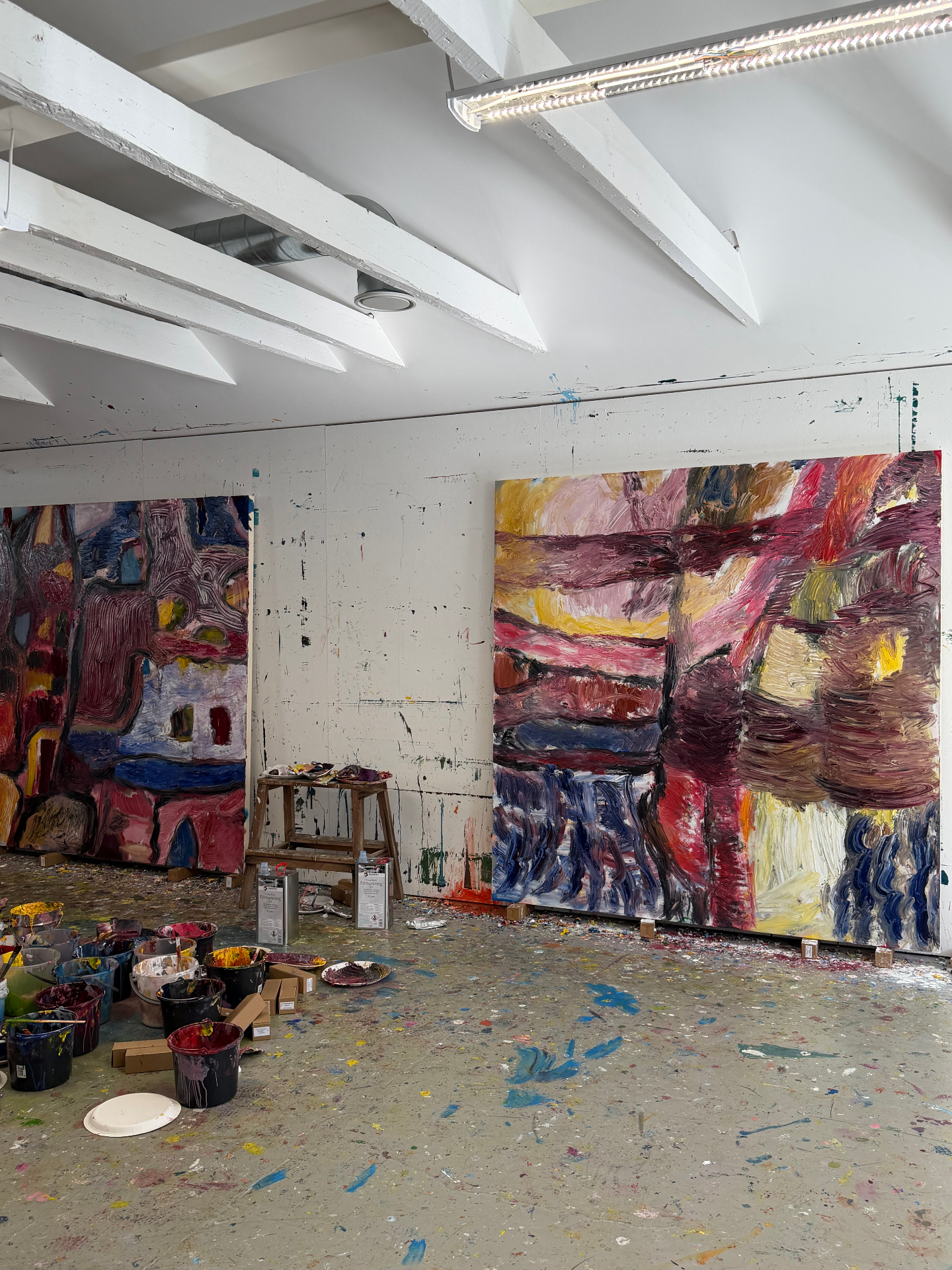 Two new large paintings on the studio wall, deep reds and pinks